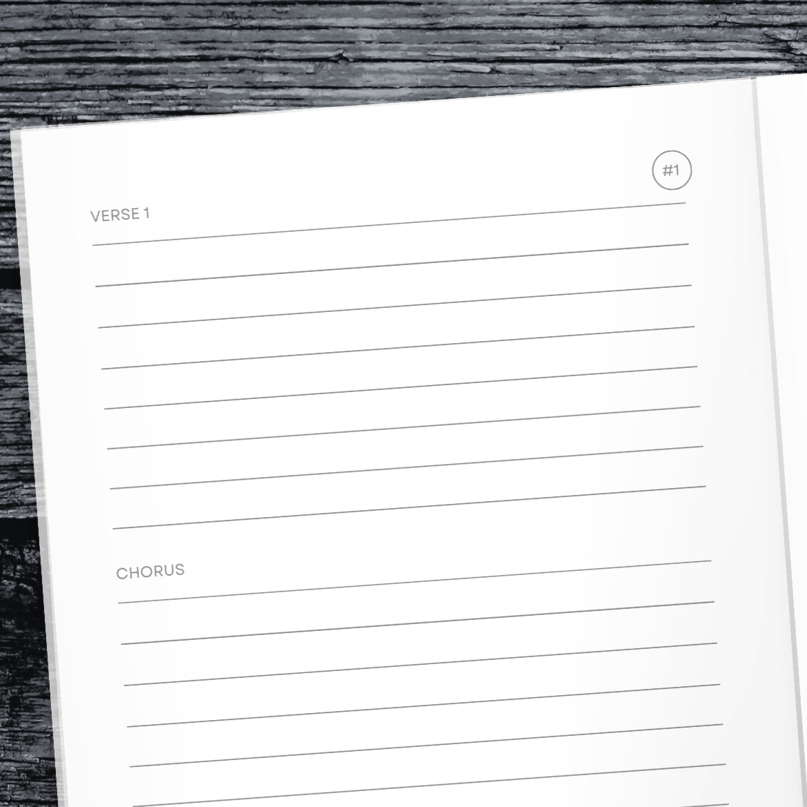 Lyrics Remembered songwriting journal open to a page for writing verses and choruses on a rustic wooden background.