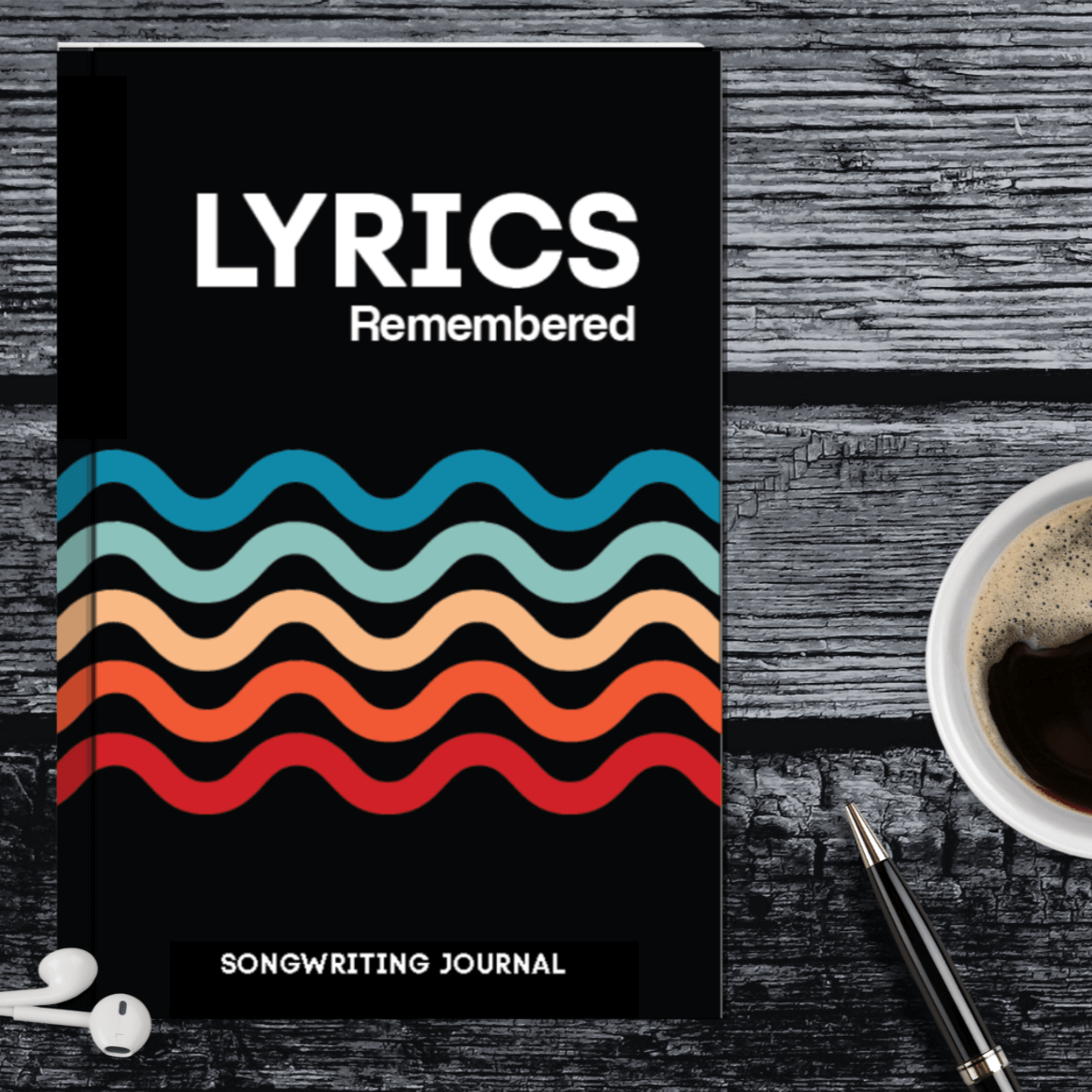 Lyrics Remembered songwriting journal with colorful wave design, surrounded by coffee cup and earphones.