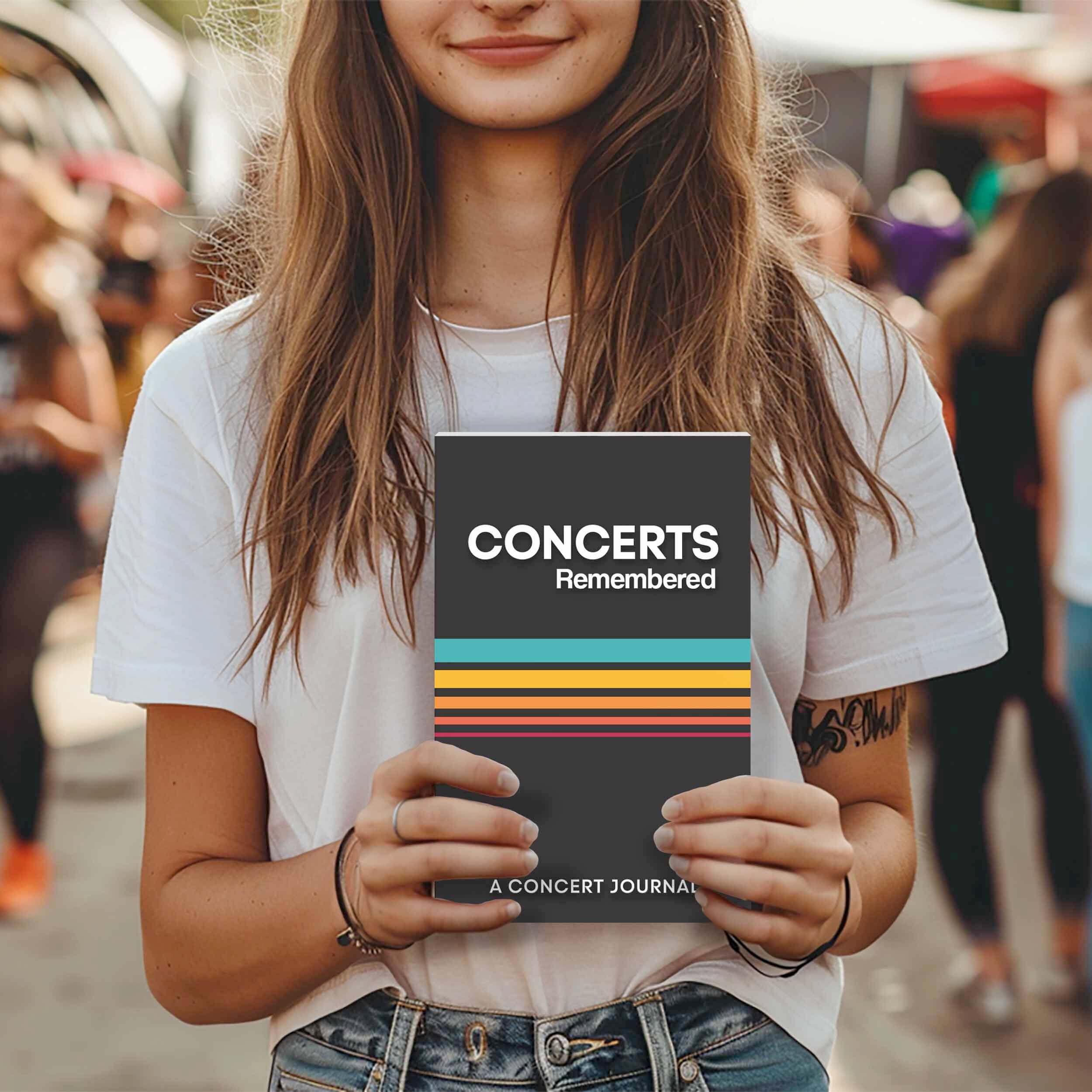 Concert goer holding Concerts Remembered journal excited about tracking their concert experiences